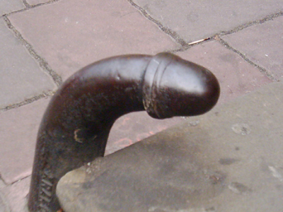 Metal thing at the base of some church steps that looks like a bent cock